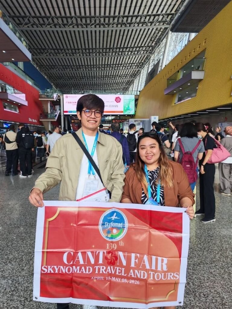 Two SkyNomad clients with the Canton Fair banner at the Guangzhou exhibition complex